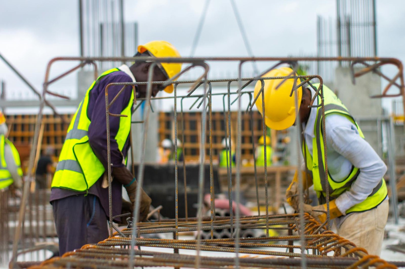 Construction workers in hard hats reviewing site safety conditions